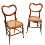 A set of six faux rosewood cane seated arm chairs