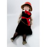 A bisque headed doll, impressed A8 England, dressed in school uniform