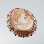 A 9 carat gold cameo brooch, the carved shell of a female profile with bead and C scroll mount, 4.
