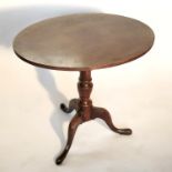 A 19th century mahogany oval occasional table, raised on a turned column terminating in a tripod