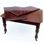 A 19th century mahogany extending dining table, raised on turned legs, having two leaves, length