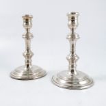 A pair of silver candlesticks, with multiple knop stems, to a stepped circular foot, London 1964,
