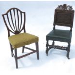 A pair of oak hall chairs, having carved back and armorial decoration, raised on carved legs