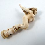 An early 19th century sailor's carved ivory pipe stopper or tamper, fashioned as a naked figurehead