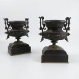 A pair of Victorian black slate mantel piece urns, with gilt decoration and gilt metal handles,