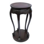 An Oriental style mahogany jardiniere stand, with circular top, raised on five scroll legs, with