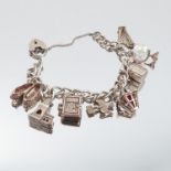 A silver bracelet, of curb links with charms attached, 43g gross