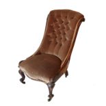 An Edwardian grandmother's chair, with carved front legs
