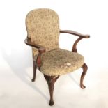 A Queen Anne style walnut spoon-back open armchair, on cabriole legs, with shell-carved knees