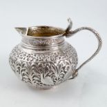 An Indian silver jug, highly embossed with birds and leaves, weight 3oz