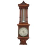 An oak cased barometer, with mercury filled thermometer, flanked by columns, the barometer dial