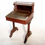 A 19th century rosewood Davenport, having a galleried shelf over and writing slope below, with