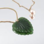 A heart shaped carved nephrite pendant, on a chain, stamped '750', together with a cultured pearl