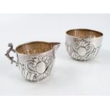 A silver milk jug and matching sugar bowl, with gadrooned decoration and both with inscriptions,