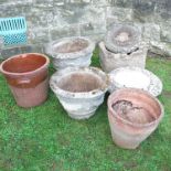 A collection of garden stoneware, to include a pair of urns,  bow front trough, a terracotta pot