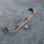 A brass and steel fire side set, comprising D shape fender, poker, tongs and shovel, with scroll and