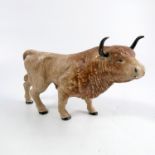 An antique painted money box, formed as a bull with long horns, 6.5ins x 10ins