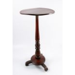 A mahogany occasional table, the circular top raised on a turned column to circular base and three