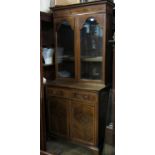 An Edwardian display cabinet, with satinwood inlay, a pair of glazed doors to the upper section, the