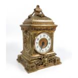 A late 19th century gilt mantle clock, with circular enamel dial with Roman numerals, height 10.