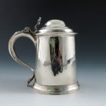 A George II silver lidded tankard, with open scroll thumb piece, plain body, inscription dated