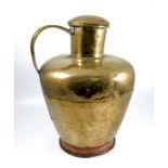 A large brass covered vessel, with handle. raised on a copper foot, height 23ins