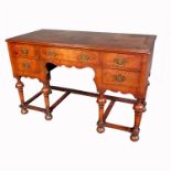 A 17th century style walnut dressing table or desk, fitted with a frieze drawer flanked by two short