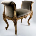 A gilt wood and upholstered window seat, of scroll form, decorated with leaves, raised on cabriole