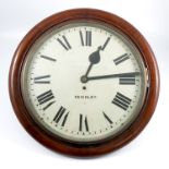 A large oak cased school clock of circular form, having a painted white dial with Roman numerals,