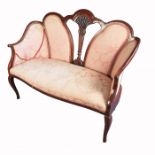 A late Edwardian salon suite, comprising a two seater sofa, with part pierced back and two