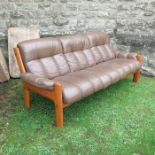 An Erkones leather and wood three seater settee, length 89ins, no fire labels