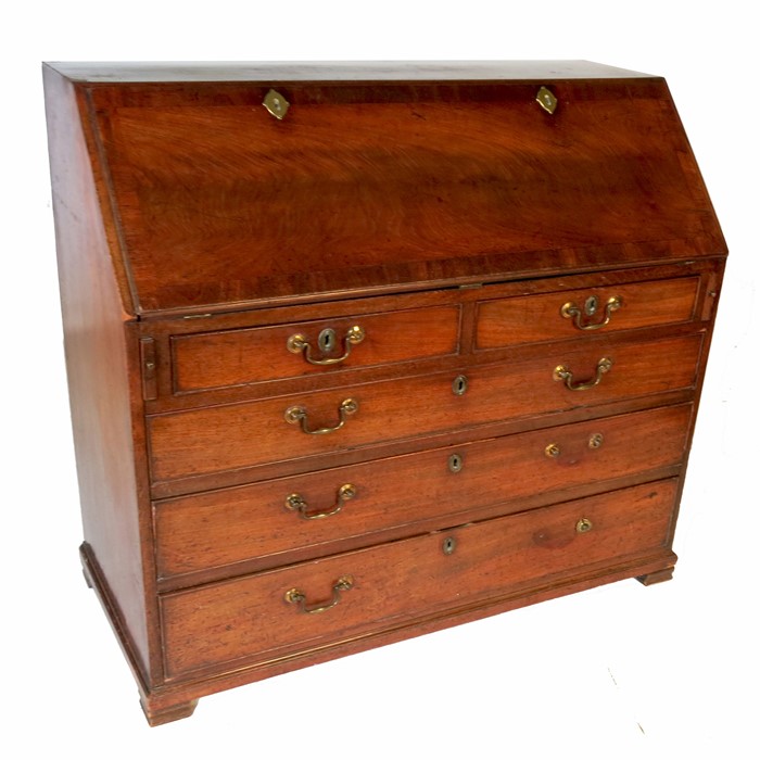 A George III mahogany bureau, the crossbanded fall flap opening to reveal a fitted interior, over