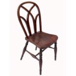 An antique  Windsor chair ,possibly Yew wood, having stylised Gothic pierced back, with solid