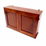 A satinwood cabinet, having fielded panels to each door, opening to reveal shelves, width 34ins,