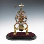 A 19th century brass scroll frame skeleton clock, under a glass dome.Condition Report: Height with