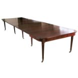 A Regency mahogany extending dining table, in the manner of Gillows, raised on ten reeded tapering