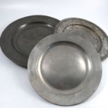 An Antique triple reeded edge pewter charger, diameter 18.5ins, together with two other pewter