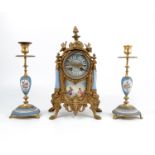 A late 19th century gilt metal and porcelain clock garniture, comprising a central clock with