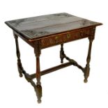 An antique oak side table, the top with carved corner decoration above single carved frieze