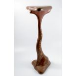 A wooden stand, formed from various pressed woods. of organic form, with triangular shaped top,