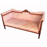 An Edwardian two seat sofa, with a central marquetry panel, raised on square tapering legs