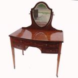 An Edwardian dressing table, with shield shaped mirror over, having two drawers over a knee hole