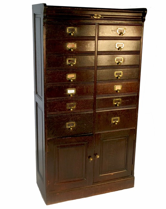 An Edwardian estate cabinet, fitted with seven pairs of drawers of varying sizes, over two