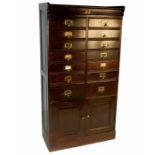 An Edwardian estate cabinet, fitted with seven pairs of drawers of varying sizes, over two