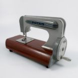 A 1950's E L Grain MK2 toy sewing, machine on a a wooden base