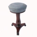 A Victorian rosewood circular piano stool, raised on a baluster support terminating in a platform