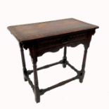 An antique style side table, having a frieze drawer, raised on turned legs united by a stretcher,