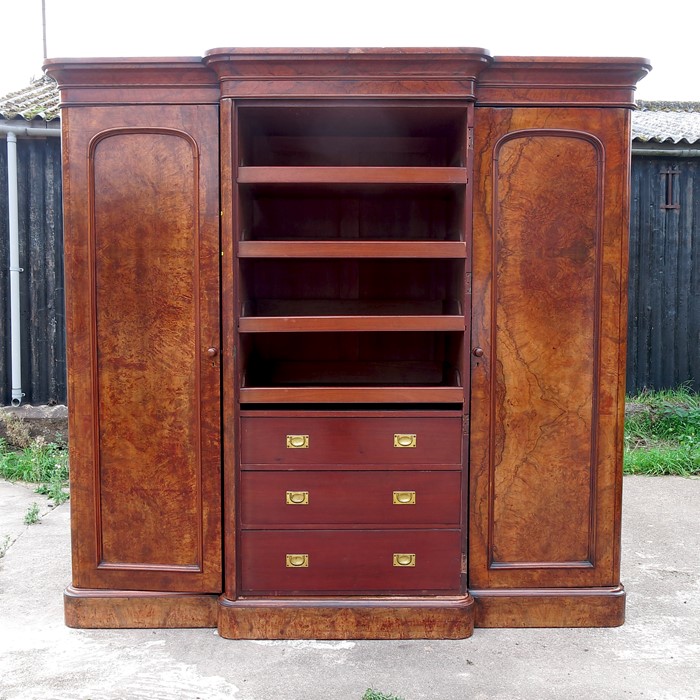 A Victorian burr walnut compactum, the central section fitted single mirror door opening to reveal