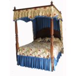 An 18th century style four post bed, with turned posts, solid headboard and floral drapes, width