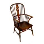 A 19th century Windsor chair, with turned legs united by stretcher